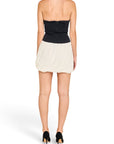 Back view of a Lost Labels Jonathan Simkhai strapless mini dress with a black corset bodice and cream bubble skirt.