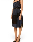 Lost Labels Nina Ricci silk dress in navy and black with a fluid drape and belted waist, worn by a model.
