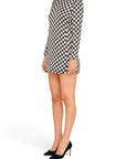 Lost Labels Saint Laurent black and white polka dot long sleeve mini dress worn with black pointed-toe pumps