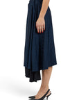 Lost Labels Vetements reversible black and navy midi skirt with all-over logo print worn by a model in black heels.