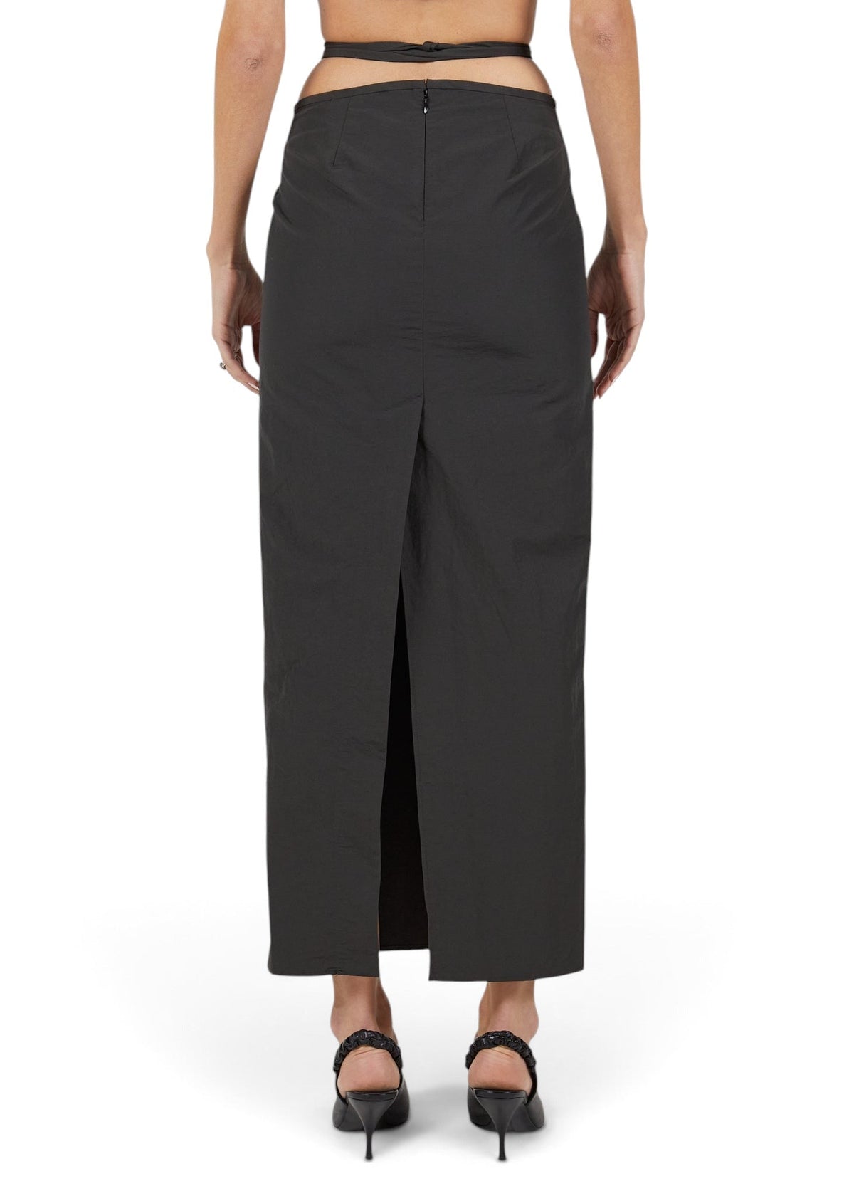Lost Labels black maxi skirt with back vent and cutout waist detail worn by a model from the back view