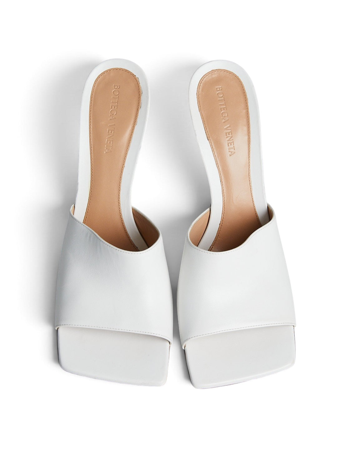 Lost Labels Bottega Veneta white leather square-toe mules with sculpted stiletto heels on a white background.