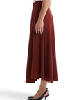 Lost Labels burgundy midi skirt by The Row featuring a fluid A-line silhouette and side view on a model
