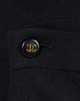 Lost Labels Chanel Boutique black midi wrap dress featuring a signature gold CC logo button detail on textured fabric