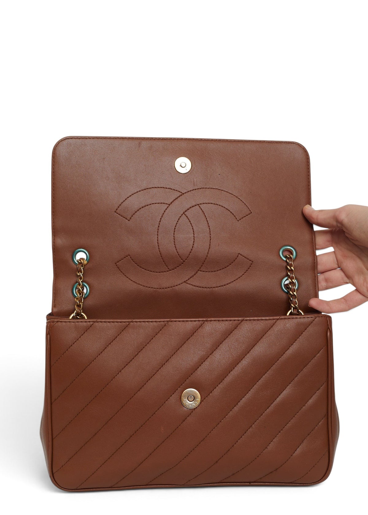 Lost Labels brown leather Chanel flap bag with diagonal quilting and gold chain strap, open view showing interior