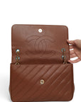 Lost Labels brown leather Chanel flap bag with diagonal quilting and gold chain strap, open view showing interior