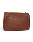 Lost Labels brown leather Chanel flap bag featuring diagonal quilting and gold chain strap, back view.