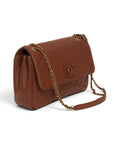 Lost Labels brown leather Chanel flap bag with diagonal quilting, gold chain strap, and signature CC logo.