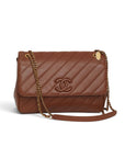 Lost Labels Chanel brown leather flap bag with diagonal quilting, gold chain strap, and signature logo hardware.