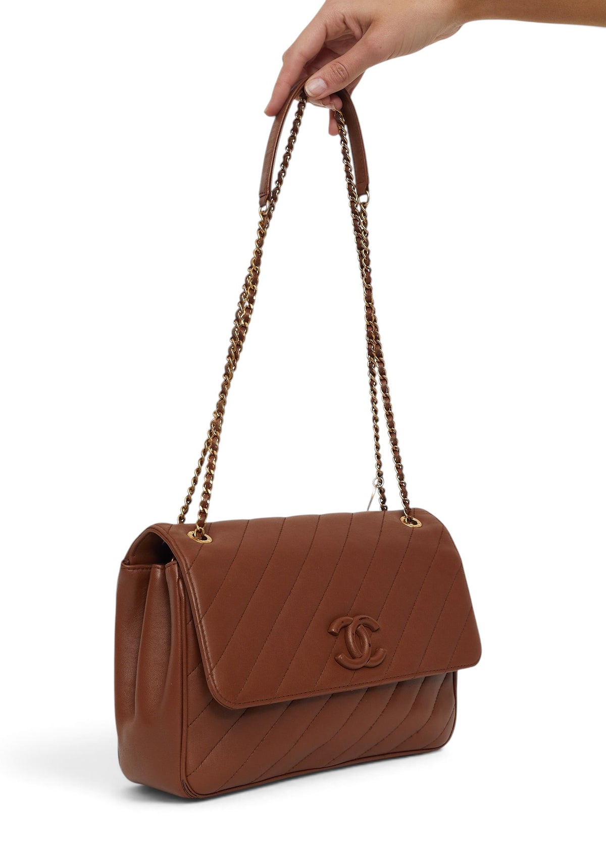 Lost Labels Chanel brown leather flap bag with diagonal quilting and gold chain strap held by hand