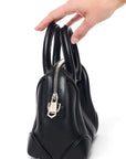 Lost Labels Givenchy mini black leather top-handle bag with silver zipper detail held by hand