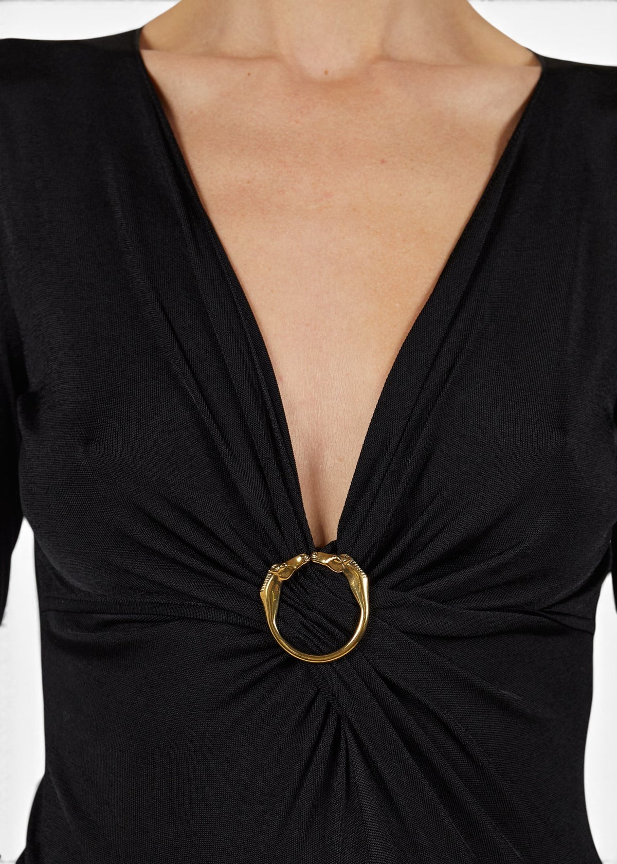 Lost Labels Gucci black long sleeve top featuring a deep V-neck and a decorative gold horsebit buckle detail.