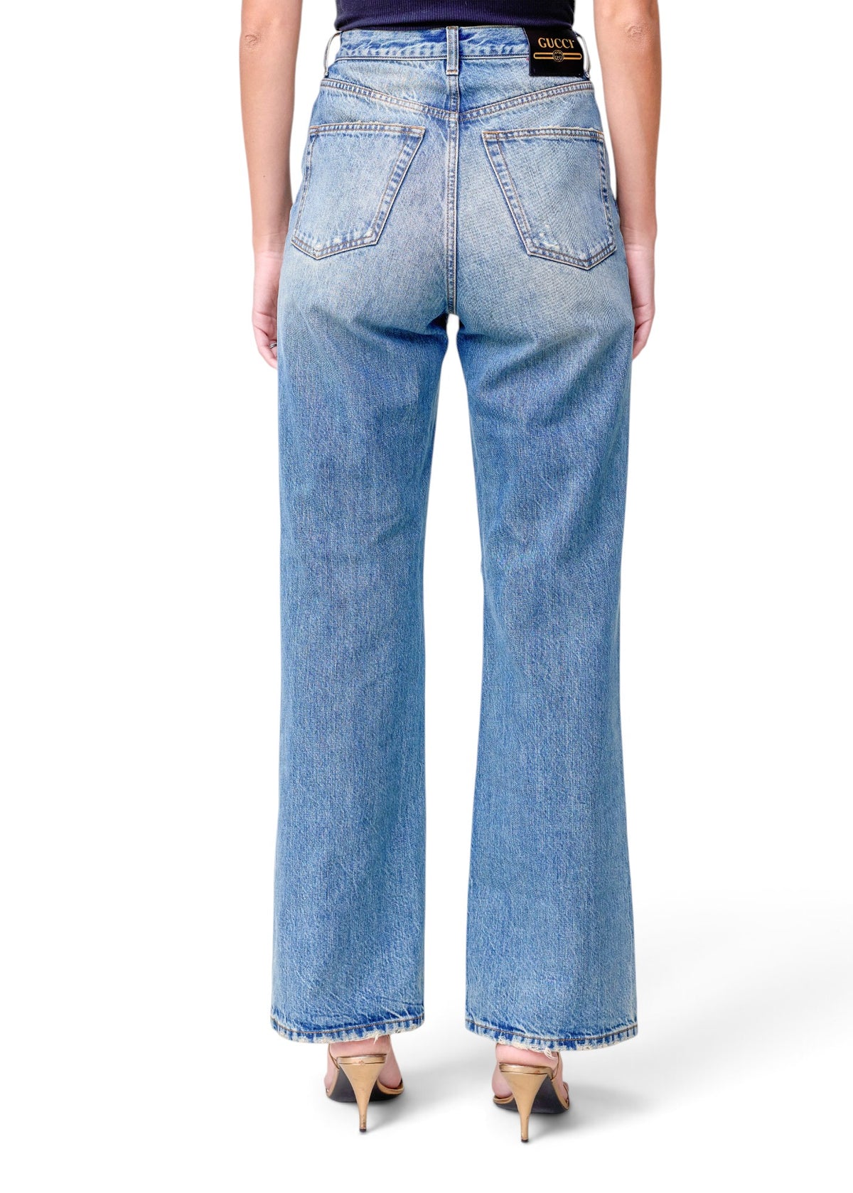 Lost Labels Gucci blue denim jeans featuring a back leather logo patch and straight leg fit on a model