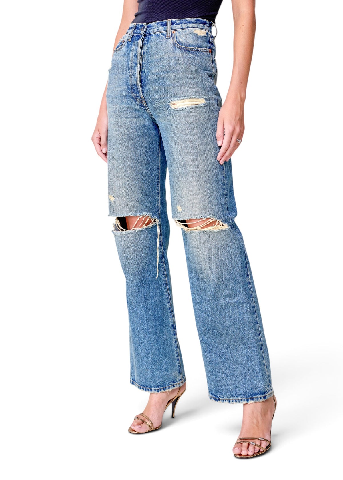 Lost Labels Gucci blue denim jeans with distressed knee rips and a straight-leg fit worn by a model.