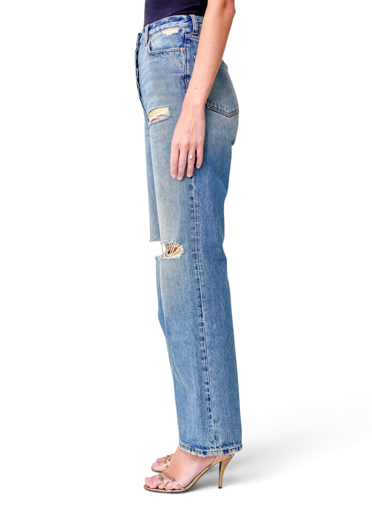 Lost Labels Gucci blue distressed denim jeans with a straight-leg fit worn by a model in gold heeled sandals