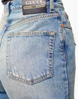 Lost Labels Gucci light wash denim jeans featuring a black leather logo patch on the back waistband