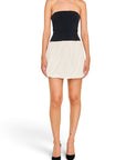 Lost Labels Jonathan Simkhai strapless mini dress with a black corset bodice and a cream pleated bubble skirt.