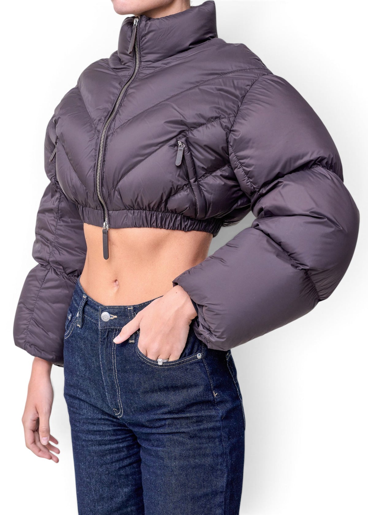 Lost Labels Khaite cropped puffer jacket in dark grey with a high collar, zip-up front, and modern silhouette.