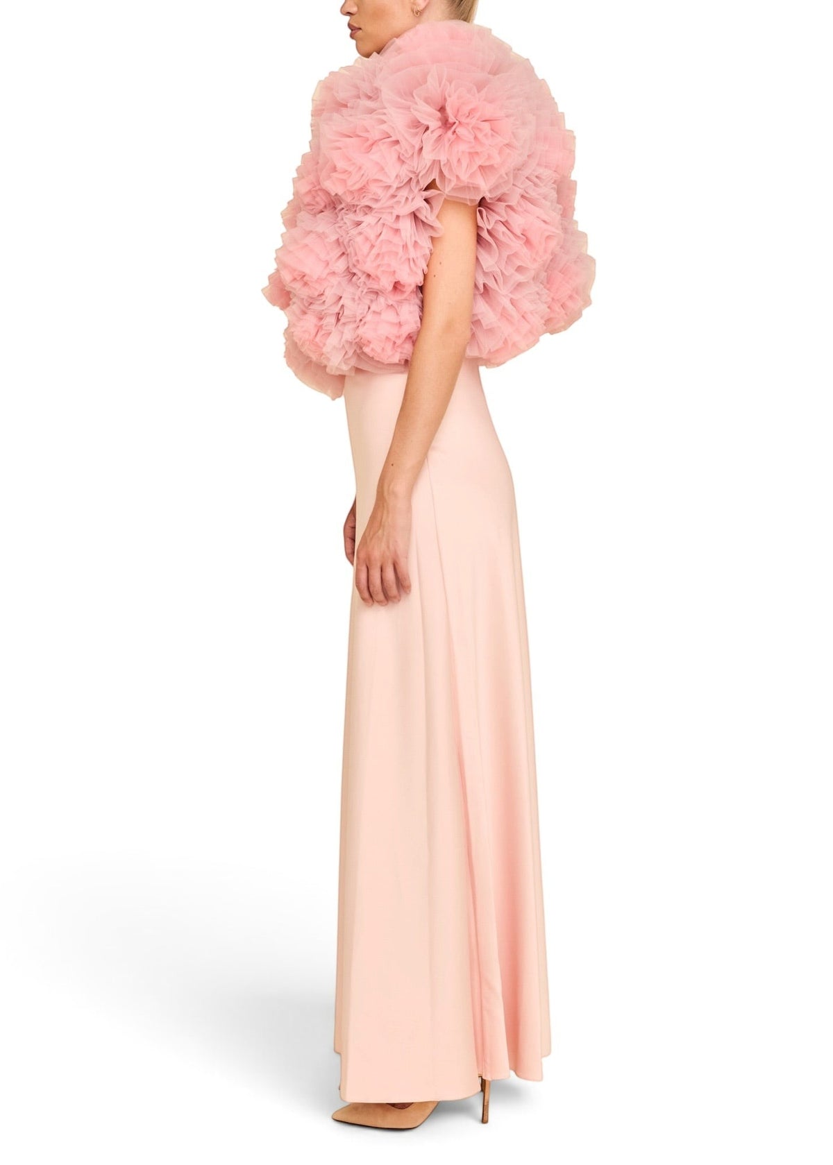 Lost Labels Linni Caro gown in pale pink with a dramatic ruffled bodice and floor-length skirt, side profile view.