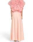 Back view of a Lost Labels Linni Caro gown in pale pink with a voluminous ruffled tulle bodice and floor-length skirt.