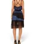 Lost Labels Nina Ricci silk dress in black and blue with a fluid drape, crisscross straps, and sheer hem detail.