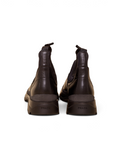 Lost Labels Prada black leather Chelsea boots with chunky rubber soles, viewed from the back.