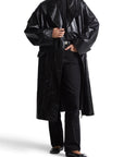 Lost Labels Ralph Lauren black crinkled leather trench coat on a model with a double-breasted longline silhouette.