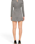 Back view of a Lost Labels Saint Laurent mini dress in black and white polka dot print with a keyhole cutout