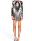 Lost Labels Saint Laurent black and white polka dot long sleeve mini dress worn by a model with black pumps