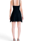 Back view of a Lost Labels Versus Versace black mini dress with thin straps and a flared hem on a model