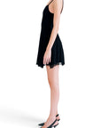 Lost Labels Versus Versace black mini dress in a viscose blend, worn by a model in a side profile view.